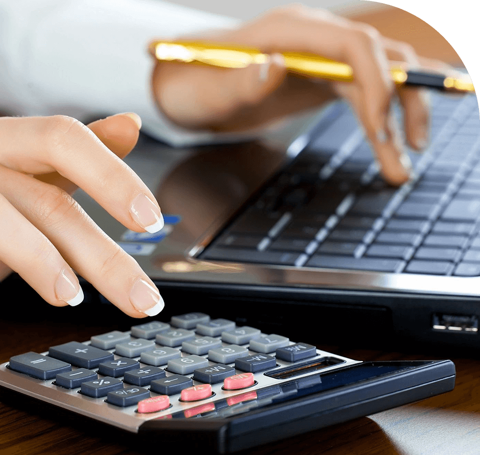 A person using a laptop and calculator