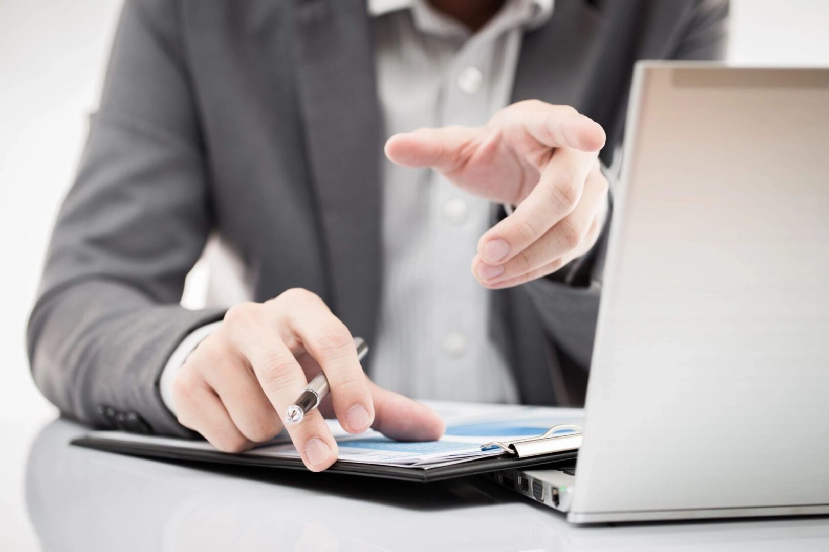 A person in a suit using a laptop